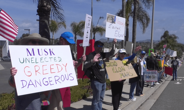 Protesters rally outside Encinitas Tesla dealership over federal cuts